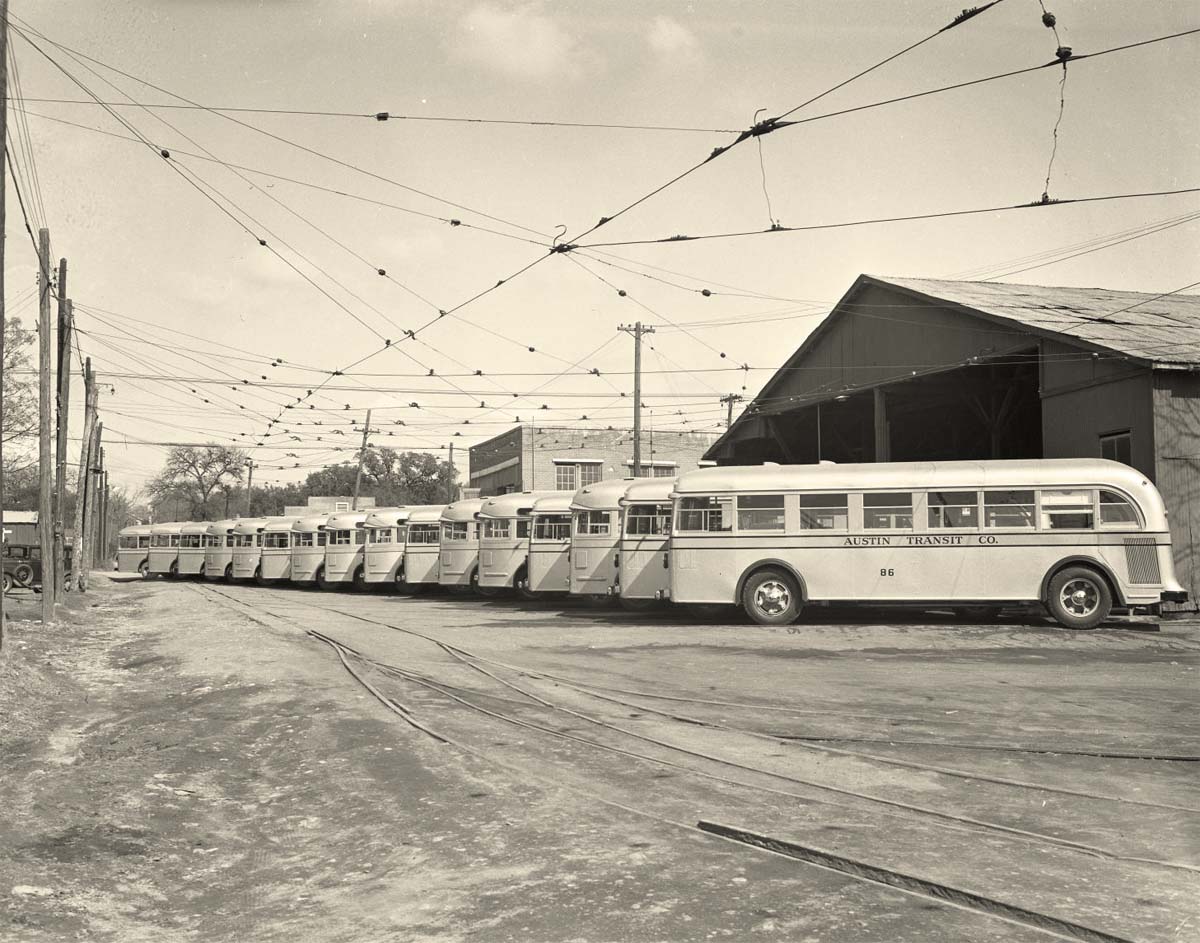 Austin, Texas. Line of buses parked outside near tracks, 1940
