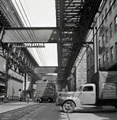 Baltimore. Trucks and trains unloading goods underneath elevated trolley, April 1943