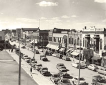 Bismarck. Downtown, to the left is the lawn of the Train Depot, 1950s