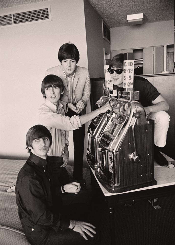 Las Vegas, Nevada. Beatles try their luck on a pair of fruit machines, 1964