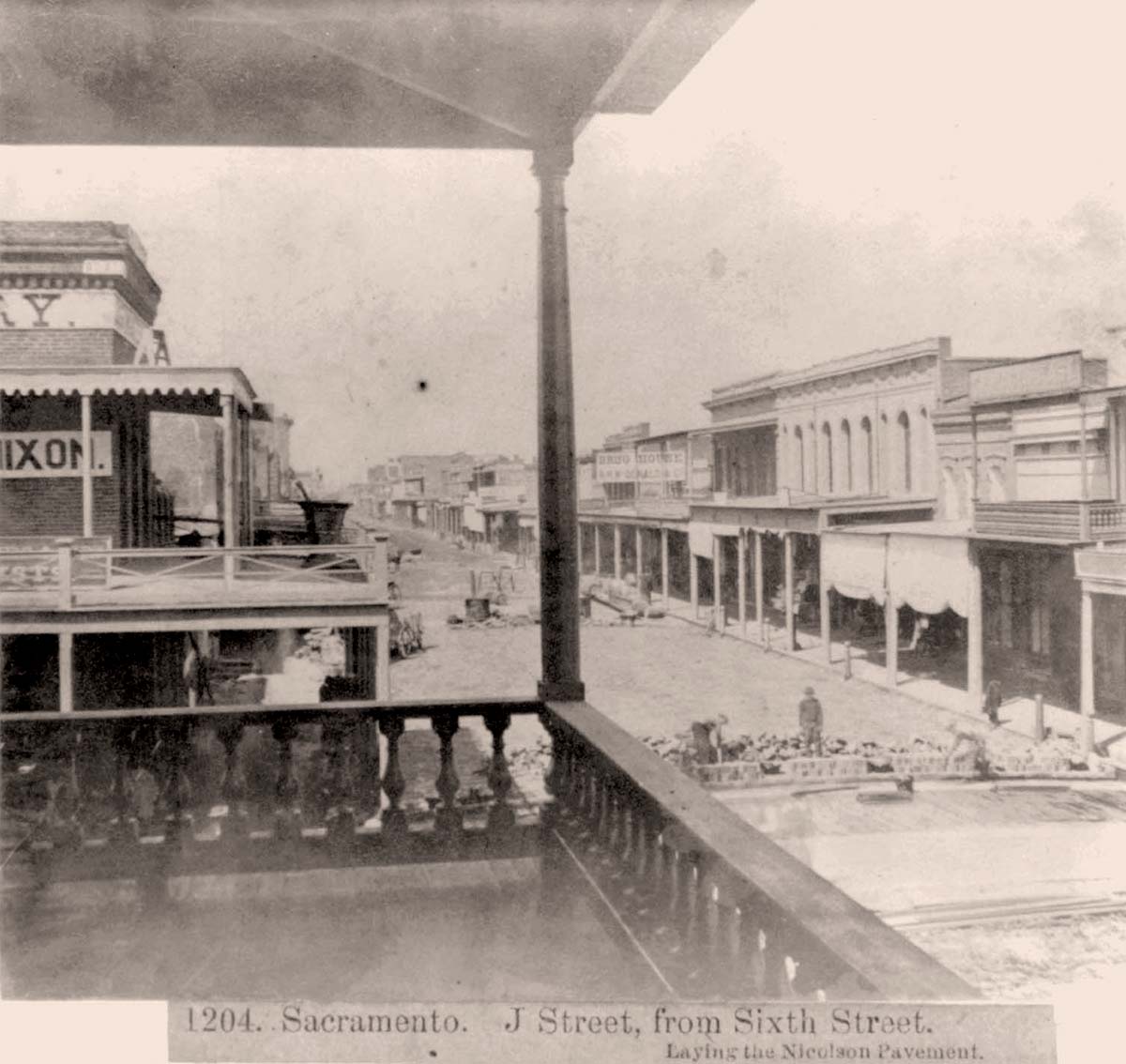 Sacramento, California. J Street from Sixth Street, laying the Nicolson Pavement, 1866