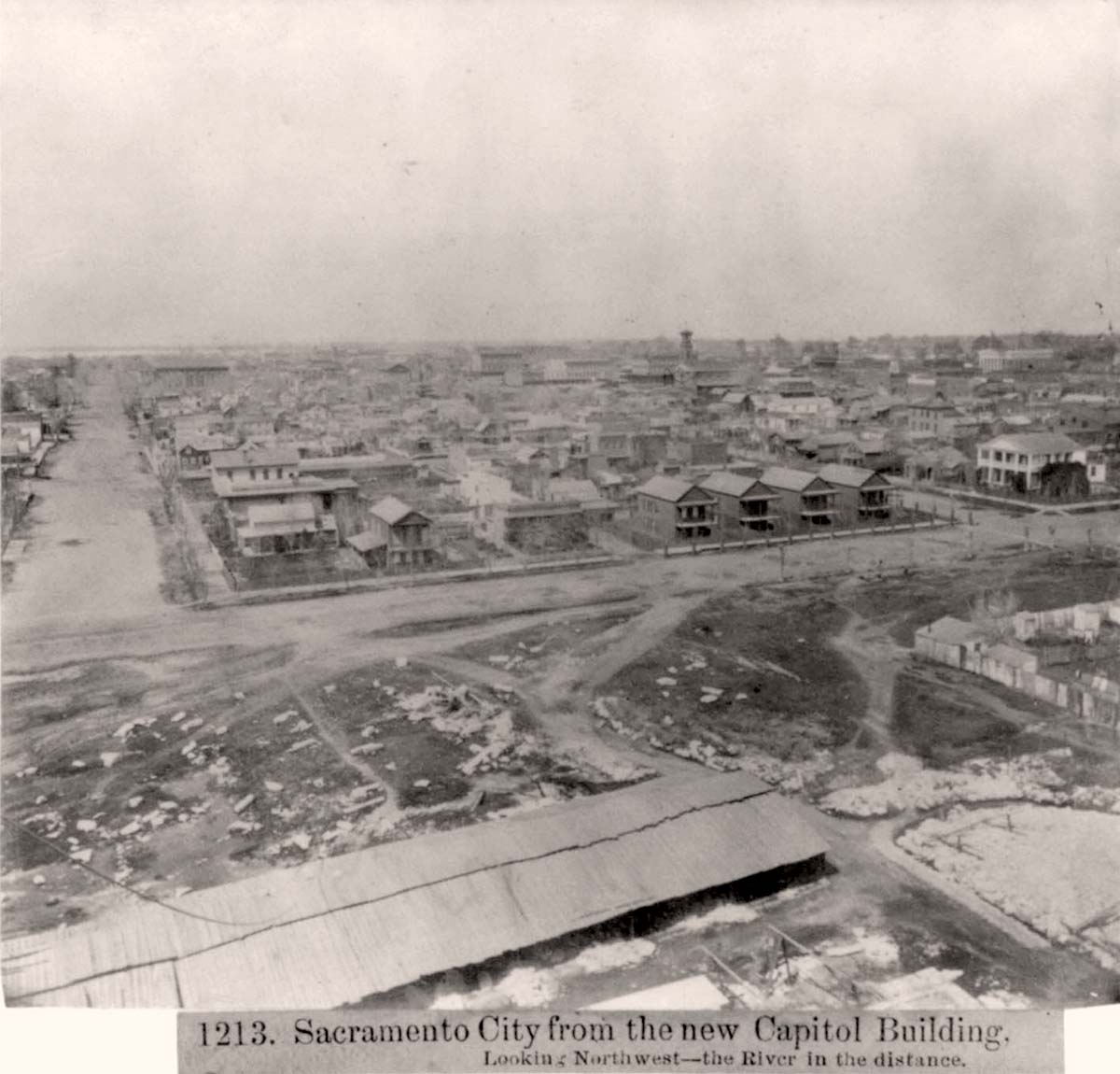 Sacramento, California. M Street and River in the distance from the new Capitol Building, 1866