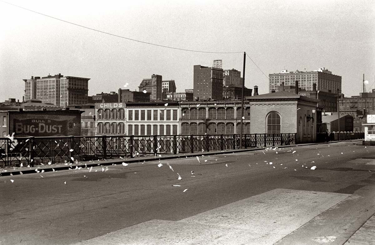 Saint Louis. Scraps of paper blowing on bridge, May 1940